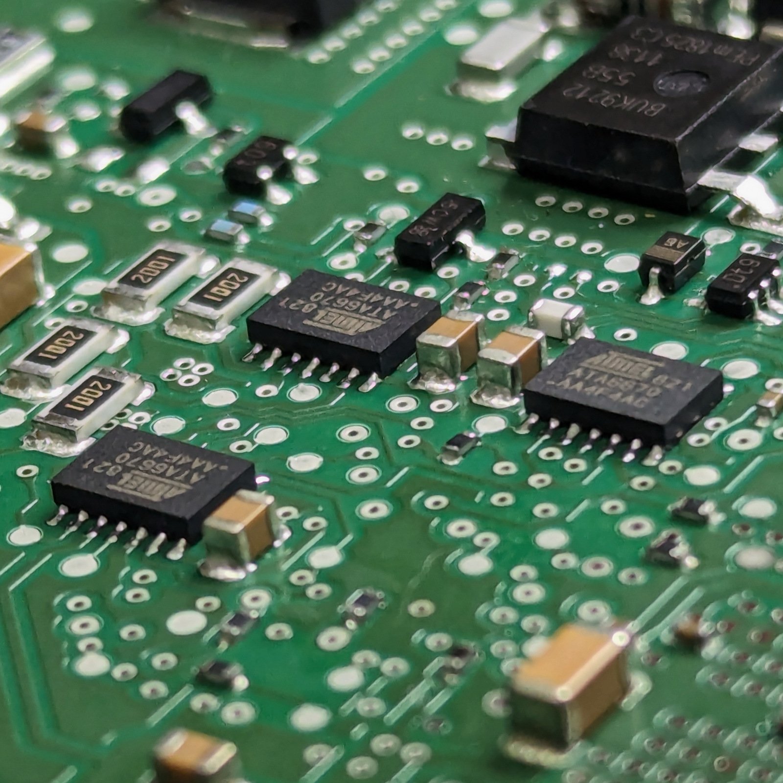 Close-up of electronic components on an automotive control unit circuit board.